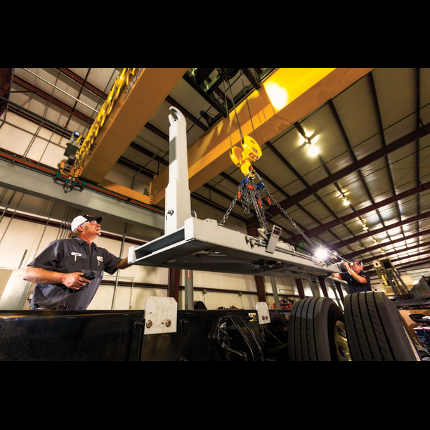 Techs installing truck body with hook lift