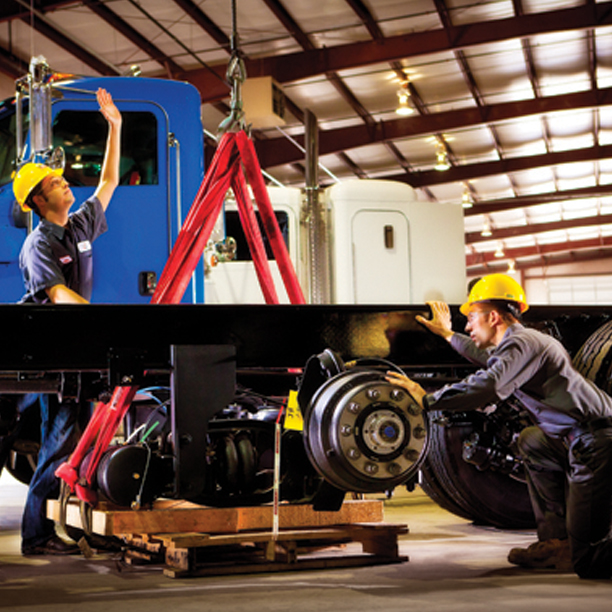 Techs working on truck axles