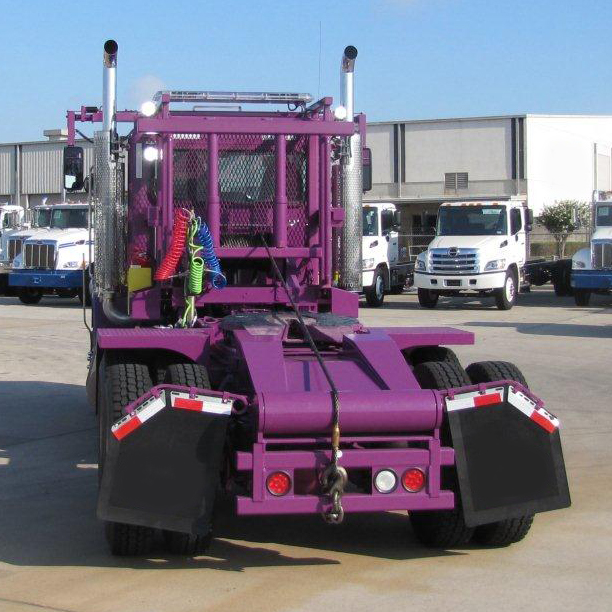 Back view of purple roll off truck