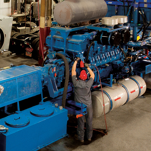 Technician working on truck in service bay