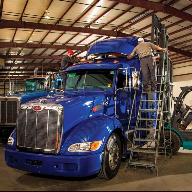 Techs installing air fairing on heavy-duty truck