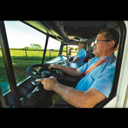 Two drivers driving truck with dual steering wheels