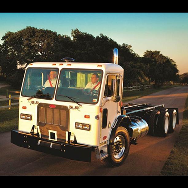 Front view of refuse truck with dual steering wheels