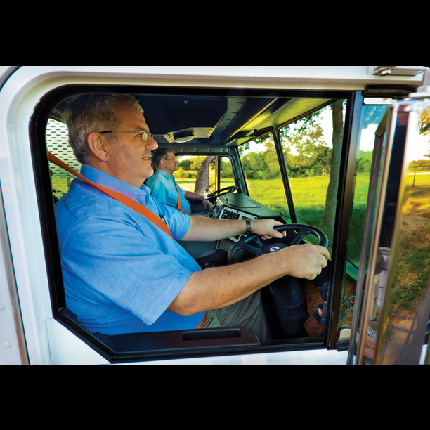 Two drivers driving truck with dual steering wheels