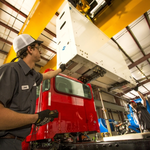 Tech installing alternative fuel system on truck