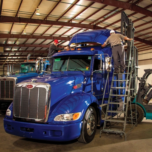 Techs working on heavy-duty truck cab