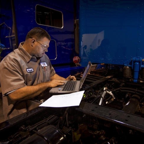 Tech performing pre-delivery inspection